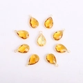 Detail of eight yellow teardrop-shaped faceted glass pendants with gold metal frames - Teardrop / Gold Base Orange-Yellow Crystal Glass