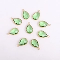 Macro view of green teardrop glass charms with gold metal edges for DIY jewelry making - Teardrop / Gold Base Green Crystal Glass