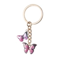 Dettaglio portachiavi con ciondolo a farfalla rosa e viola e anello in metallo dorato - Stile Doppia Farfalla / Rosa