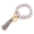 Dettaglio di perline in legno lavanda con accento geometrico e nappa chic con stampa serpente - Base Argento Viola