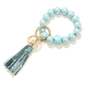 Detail of light blue beaded bracelet keychain with snakeskin print tassel and gold ring - Sky Blue Silver Pattern