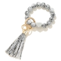 Close-up of snakeskin pattern beads and tassel keychain with golden metal ring - White Silver Pattern