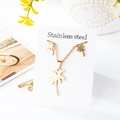 Macro detail of golden stainless steel palm tree pendant necklace and stud earrings set - Palm Tree Design