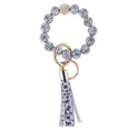 Detail of cow print beaded bracelet keychain with wooden bead and tassel accessory - Digital Wood Beads