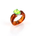 Close-up of amber resin ring featuring a vibrant neon green square crystal in silver prong - Green Stone Brown Resin Ring