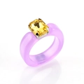 Macro view of a purple resin ring with a large rectangular yellow crystal in silver claw setting - Yellow Stone Purple Resin Ring