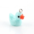 Macro shot of a light blue resin duck charm with a metal ring for DIY jewelry making - Light Blue