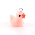 Detailed view of a pink resin cartoon duck pendant with a silver metal loop for DIY jewelry - Pink