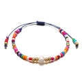 Ethnic beaded bracelet with freshwater pearl and adjustable blue cord on white background - Colorful