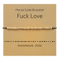 Detail of handmade Morse Code gold bead bracelet on Fuck Love kraft card display - Fuck Love