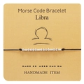 Detail of Libra Morse code bracelet with silver beads on a card holder - Libra