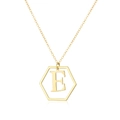 Macro detail of gold hexagonal pendant featuring an embossed letter E on a fine O-chain - Letter E