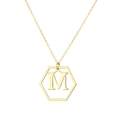 Macro shot of gold-plated hexagonal pendant featuring the letter M on a fine O-chain - Letter M