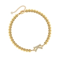 Macro detail of gold beaded bracelet featuring a sparkling zircon-encrusted letter K charm - Letter K