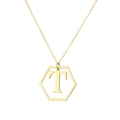 Detail of a golden hexagonal pendant with letter T on a slim cross-chain necklace - Letter T