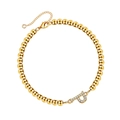 Detail of a gold bead bracelet featuring a pave-set crystal letter P charm and lobster clasp - Letter P