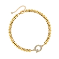 Detailed macro view of gold beaded bracelet featuring a sparkling crystal pave letter Q charm - Letter Q