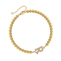 Close-up of gold beaded bracelet with crystal-paved letter R charm and lobster clasp - Letter R