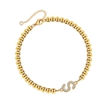 Macro shot of gold bead bracelet featuring a diamond-encrusted letter S pendant and clasp - Letter S