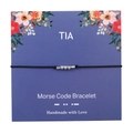 Detailed view of handmade Morse code bracelet with silver beads on a floral display card - TIA