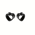Close-up of black acrylic heart-shaped ear gauges with a polished finish for body piercing - 6mm / Black