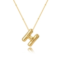 Macro detail of bubble letter H pendant with star patterns and beaded gold chain - Letter H
