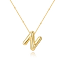 Detailed macro of gold-plated balloon letter N pendant on a delicate satellite chain - Letter N