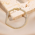 Classico bracciale tennis dorato con zirconi rotondi chiari dallo stile minimalista - Stile Bracciale Tennis Largo Dorato
