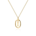 Macro shot of 18K gold letter I pendant with oval frame on a delicate cable chain - Letter I