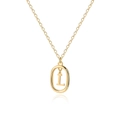Close-up of golden letter L pendant with oval frame on a delicate O-link chain - L
