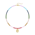 Detail of multi-color beaded necklace with a golden 18K bubble letter B pendant - Letter B
