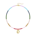 Close-up of rainbow beaded necklace with gold plated bubble letter D pendant detail - Letter D