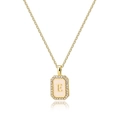 Close-up of gold rectangle pendant with shell inlay, zircon border and letter E detail - Letter E