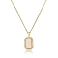 Detailed close-up of gold rectangle shell pendant with letter I and zircon stones - Letter I