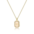 Macro detail of gold octagonal pendant with K initial, zircon border and shell inlay - Letter K