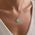 Close-up of gold necklace with blue star pendant worn by a model in a white shirt - Light Blue Starry Sky Pentagram Style (xp-178)