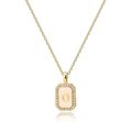Macro detail of golden octagonal pendant with white shell inlay and zircon letter O - Letter O