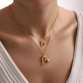 Double-layered gold necklace with two irregular hollow heart pendants on a model - Double Layer Hollow Heart Style (xp-185)