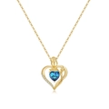Detail of 18K gold heart necklace with blue gemstone and elegant rose accent - September
