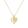 Macro detail of 18K gold heart pendant with yellow gemstone and rose engraving - November