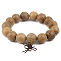 Detailed view of natural wooden prayer beads with unique grain and dark brown Chinese knot - Spiral Pattern Bead Style (4767-J1103) / 15mm