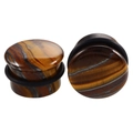 Macro view of natural tiger eye stone ear plugs with black rubber O-ring secure fixings - Tiger Eye-A