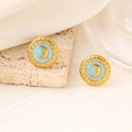 Detail shot of golden crescent moon studs with light blue enamel and cloudy texture - 18K Gold / Green