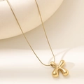 Detailed macro of 18K gold letter pendant with polished finish on sleek snake chain - Letter X Bubble Style (XL152-X)