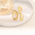 Golden irregular twisted open ring featuring an elegant spiral design on a ceramic tray - Twisted Rope Spiral Style (JZ021) / Gold