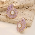 Macro detail of gold conch stud earrings with lavender enamel and centered white pearl - Purple