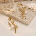 Irregular 18K gold plated bow earrings with white pearls on a minimalist stone background - Bowknot Pearl Style (EH562)