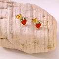 Macro detail of red strawberry earrings with green leaves on natural stone base - Strawberry Studs Style B