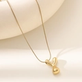 Polished 18K gold letter Y pendant with snake chain on minimalist ceramic display - Letter Y Bubble Style (XL152-Y)