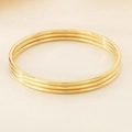 Detailed view of three polished 3mm gold stainless steel bangles with glossy finish - Set And 3 / Gold (SZ051)